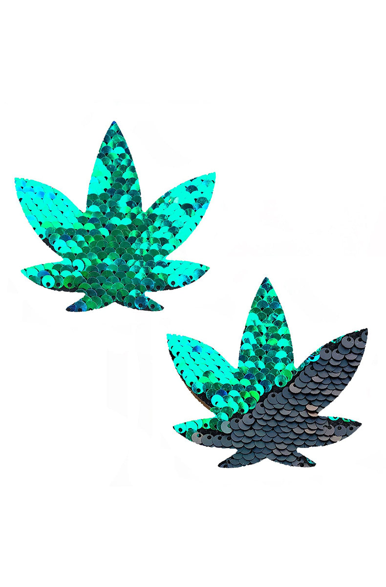 Two cannabis-leaf-shaped pasties covered in flip sequins that read turquoise green one direction and dark navy the other.
