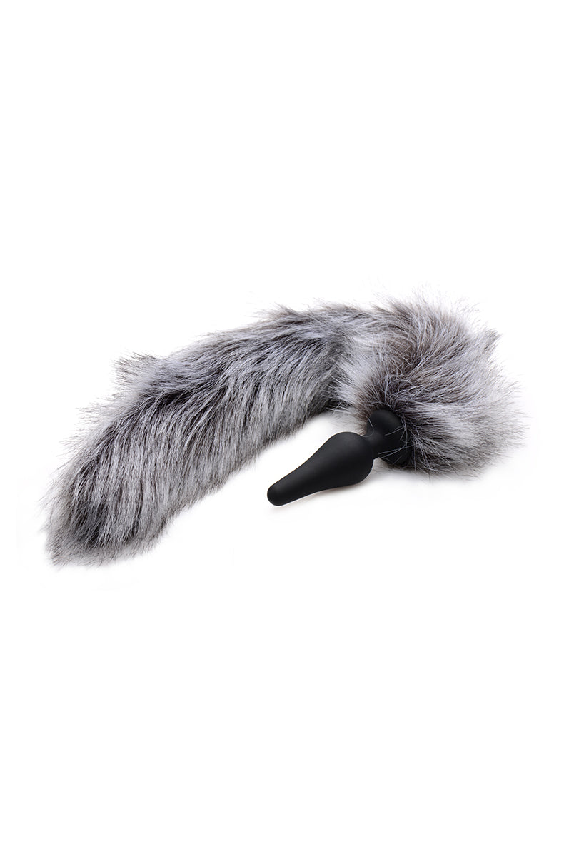 Close-up of the black silicone tapered wolf-tail plug with the round flared base and long grey faux fur tail.