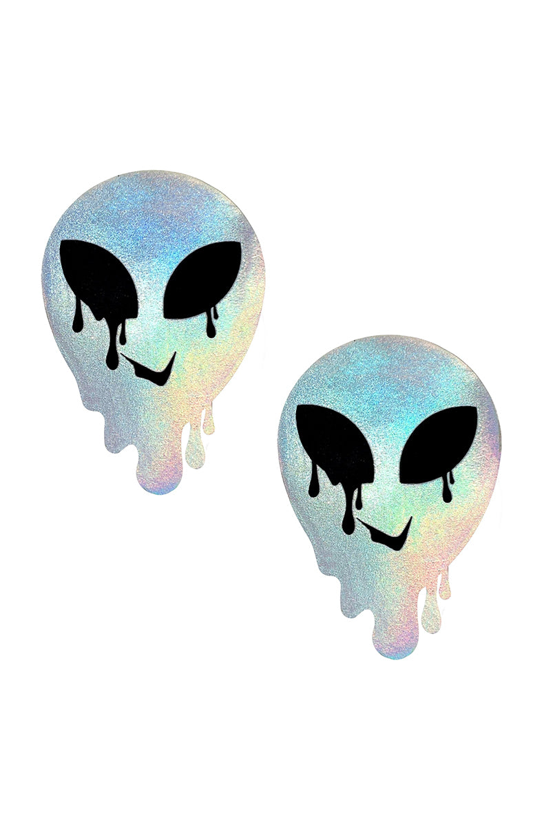 Two melting alien-head silhouette pasties in pastel rainbow holographic finish with black almond eyes and drip details.