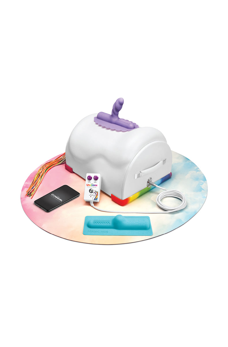 Cowgirl Unicorn sex machine with purple unicorn attachment, corded LED remote, rainbow tail flogger, and storage tray.