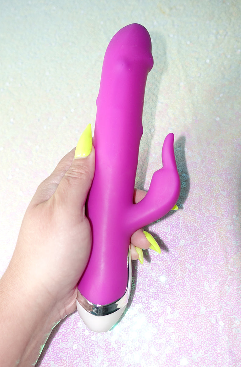 Angled product shot of the Dancing Pearl rabbit vibrator highlighting the chrome accent ring and the control buttons.