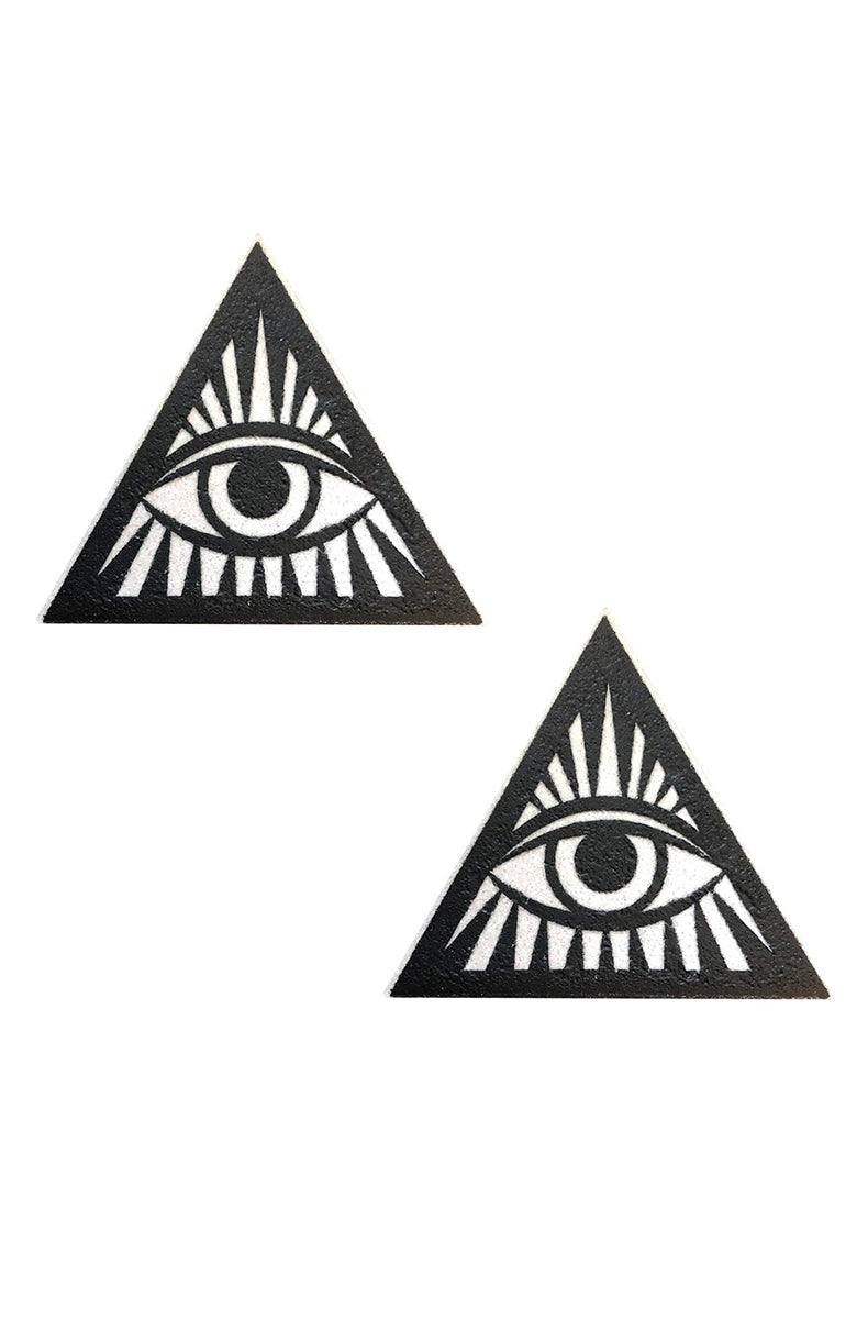 Two triangle-shaped pasties in black glitter with a white all-seeing-eye design and radiating sun-ray lines at the center.