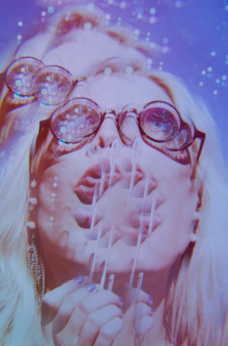 Heart-shaped sunglasses with glossy black frames and faceted iridescent kaleidoscope crystal lenses.