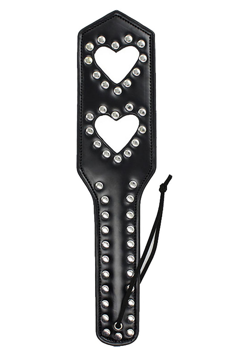 Black vegan leather paddle with two heart-shaped cutouts outlined in silver studs and a row of studs down the handle.