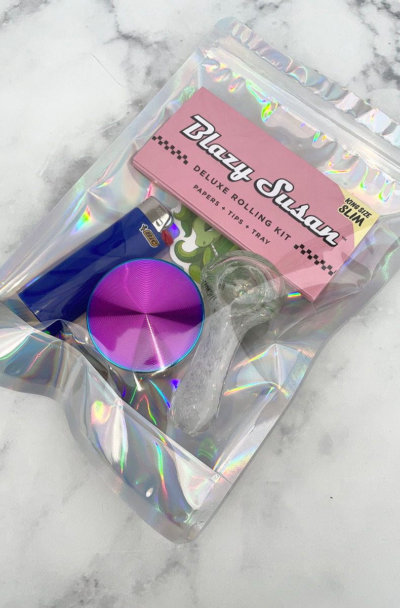 4-part rainbow metal grinder with a blue Bic lighter on a holographic smell-proof bag.