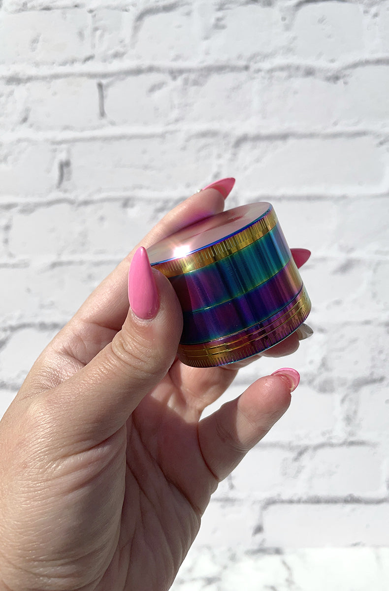 Stoner unicorn kit: purple swirl glass chillum pipe, hinged glass storage jar, 4-part rainbow grinder, smell-proof bag.