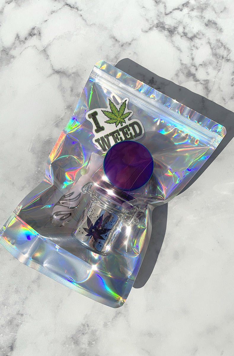 Purple swirl borosilicate glass chillum pipe on a holographic smell-proof bag.