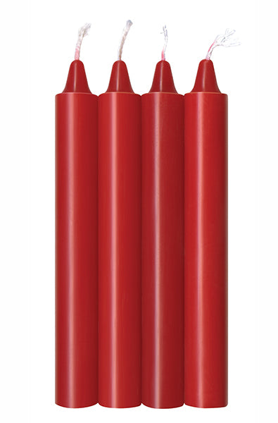 Four red taper-style wax play candles standing upright in a row with white cotton wicks on a white background.
