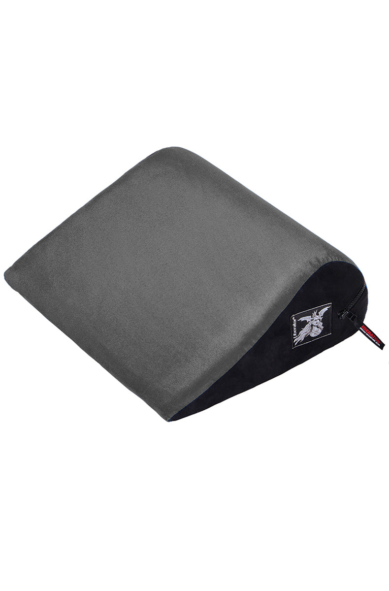 Gray velvish covered Liberator Wedge sex position pillow, sloped triangular foam bolster with black side panel and zipper.