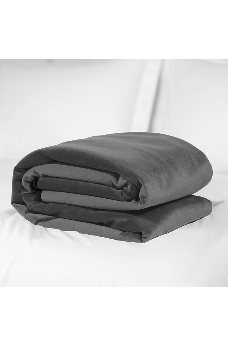 Liberator Travel Throw partially unrolled showing the soft top fabric with the moisture-barrier liner inside.
