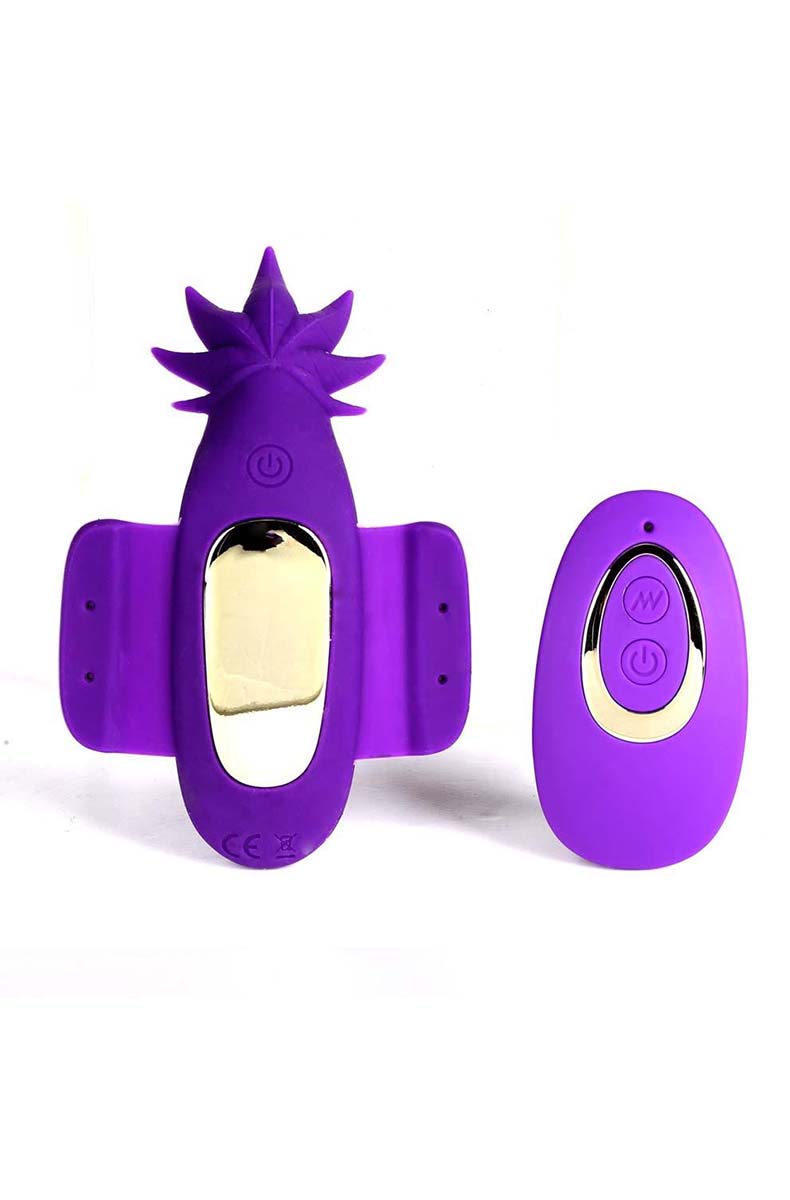 Purple silicone cannabis-leaf shaped Sativa panty vibrator with magnetic side flaps, beside a matching purple remote control.