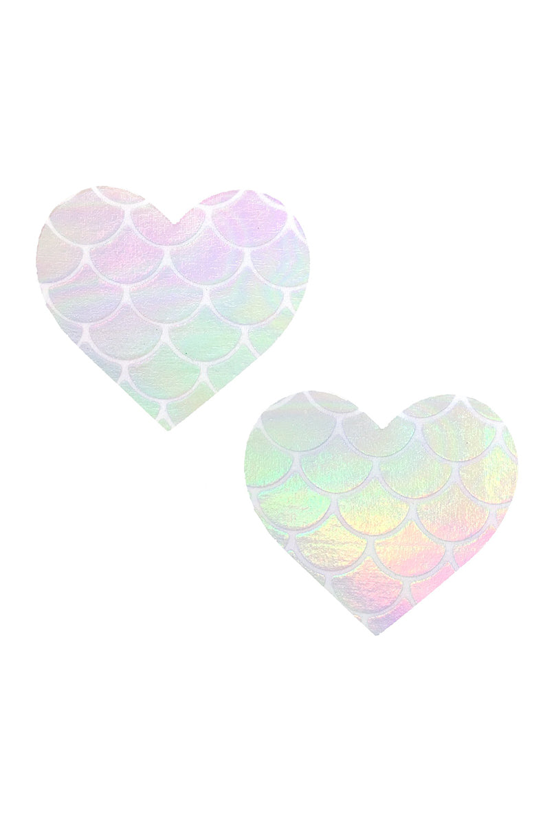 Two heart-shaped pasties with white-outlined mermaid-scale pattern over an iridescent base that shifts pink, mint, lavender, and peach.