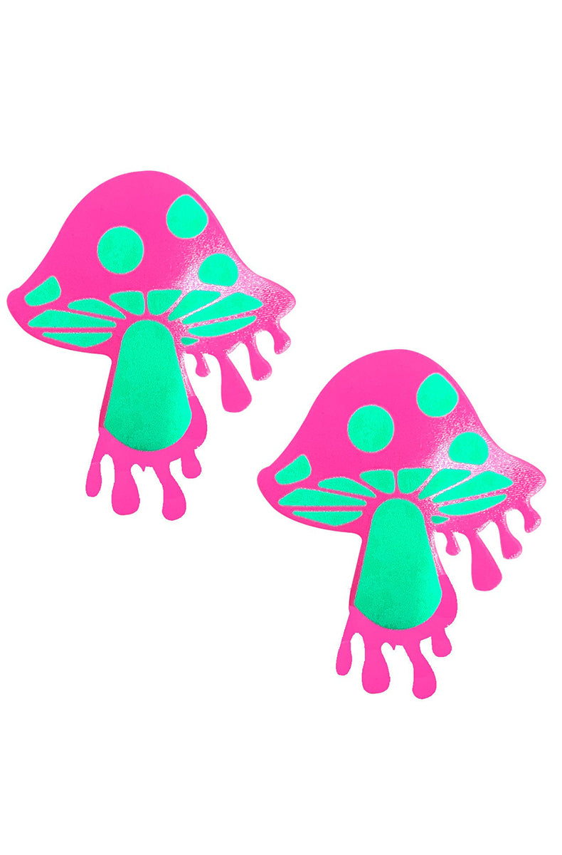 Two mushroom-shaped pasties in neon hot pink with mint-green spots, gill detail, stem, and melty drip bottom.