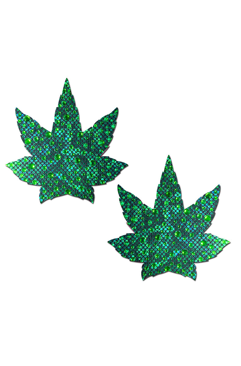 Two cannabis-leaf-shaped pasties faced from edge to edge in green rhinestones in mixed shades of emerald, mint, and dark green.