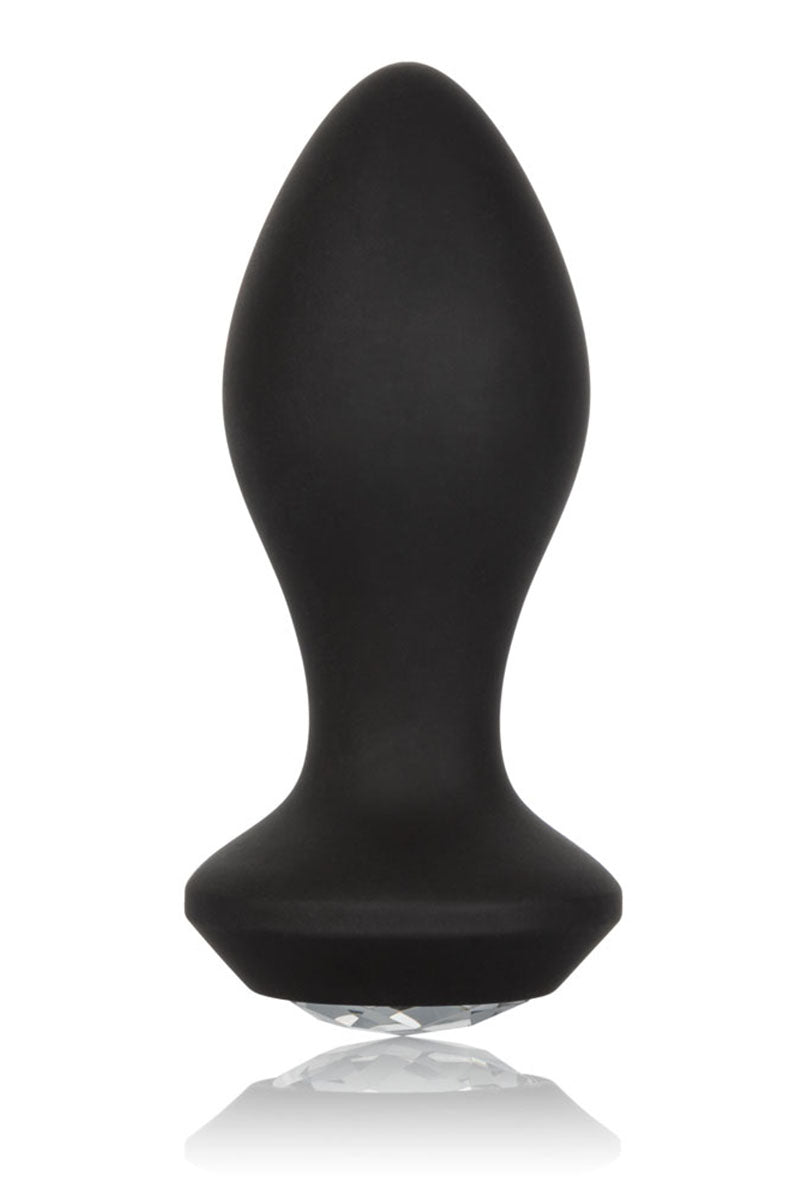 Black silicone tapered anal plug with a flared base set with a clear faceted crystal gem, on a white background.