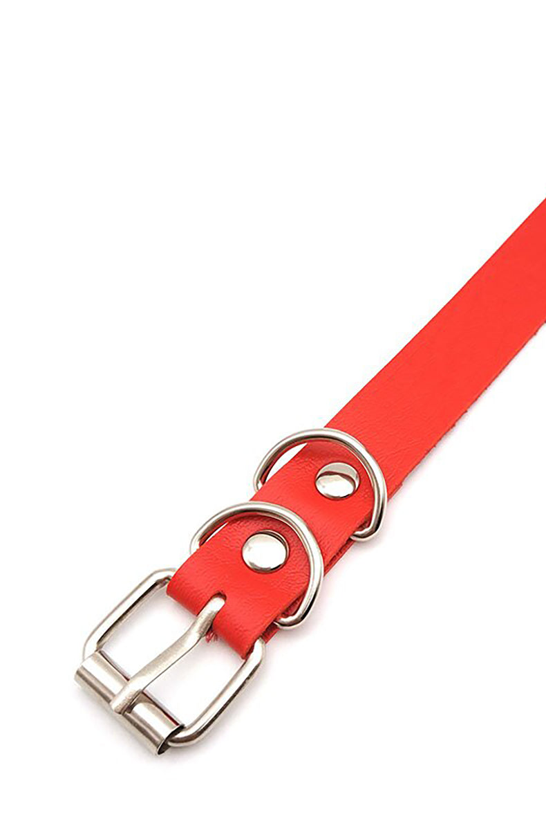 Pink, black, and red vegan leather collars with silver rhinestone-encrusted letters spelling CUSTOM as a sample, all with silver buckles.