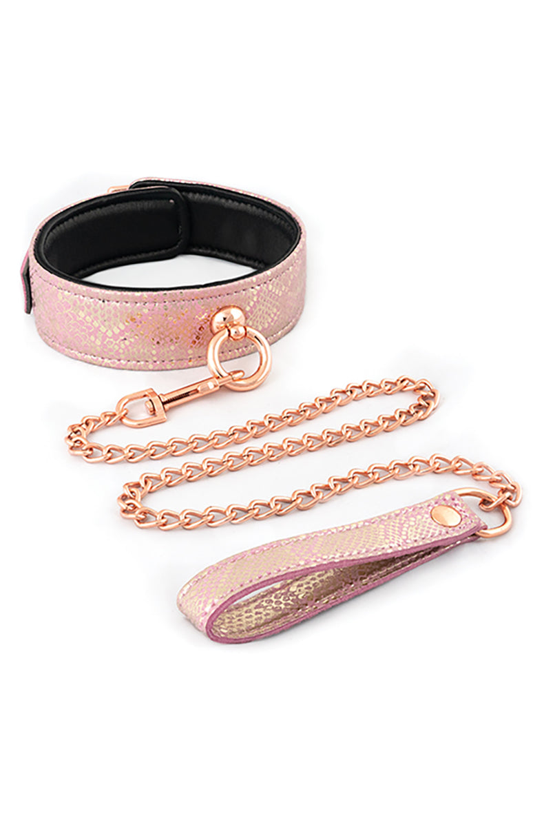 Pink iridescent snake-skin collar with black leather lining, rose-gold O-ring, and a matching rose-gold chain leash.