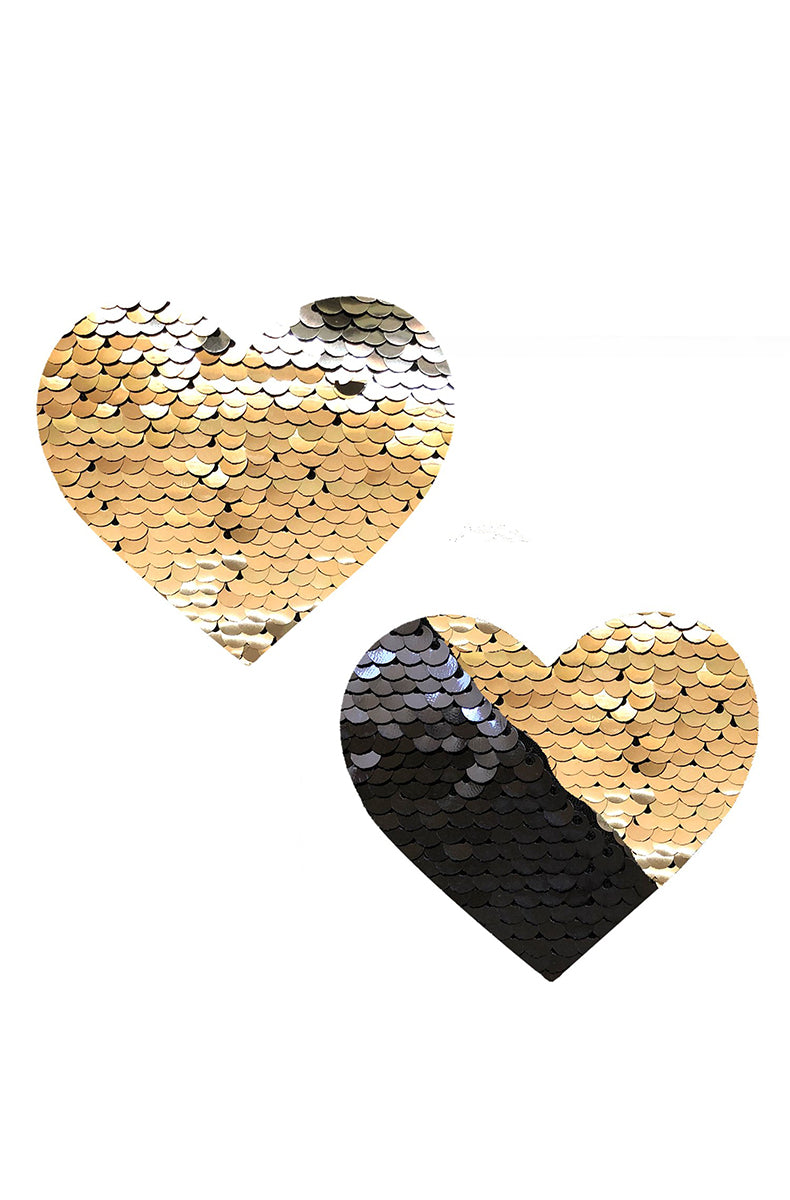 Two heart-shaped pasties covered in flip sequins that read gold one direction and black the other.