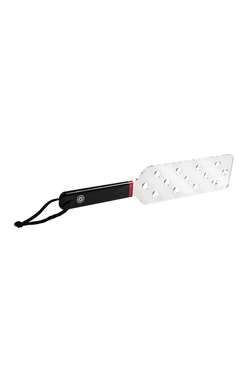 Angled view of the clear acrylic paddle showing the perforated head joined to the black handle with a red accent ring.