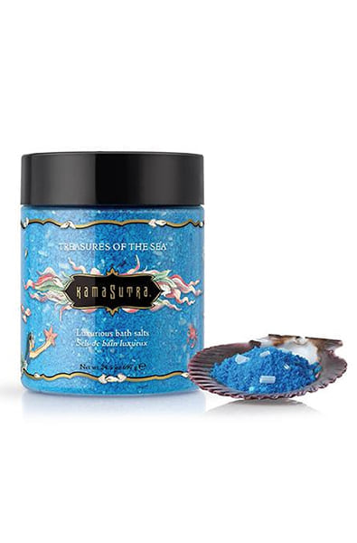 Kama Sutra Treasures of the Sea bath salt jar in blue with a real seashell scoop on a white background.