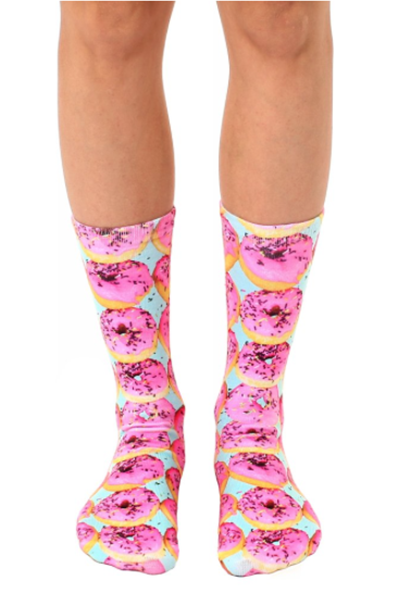 Crew socks printed with photo-real pink-frosted sprinkle donuts on a soft teal background.