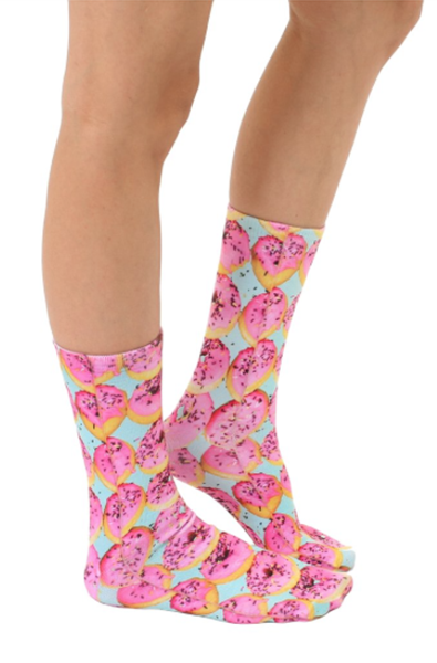 Crew socks printed with photo-real pink-frosted sprinkle donuts on a soft teal background.