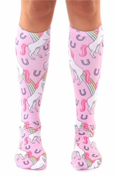 Pink knee-high socks with prancing white unicorns, rainbows, and silver horseshoes printed all over.