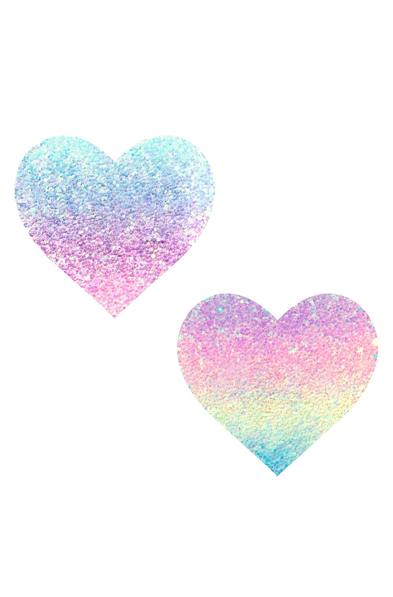 Two heart-shaped pasties in chunky pastel-rainbow ombre glitter blending pastel blue, lavender, pink, and mint.