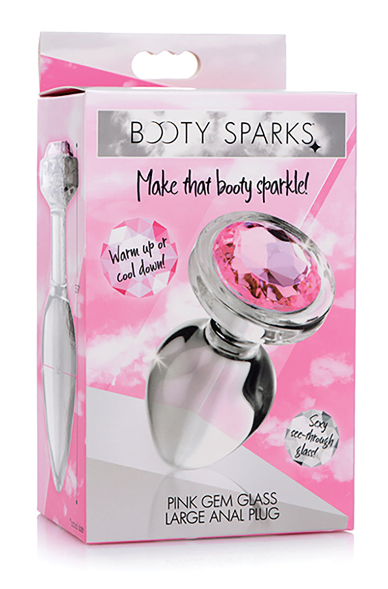 Booty Sparks large clear glass butt plug shown next to its pink retail box on a pink-and-white background.