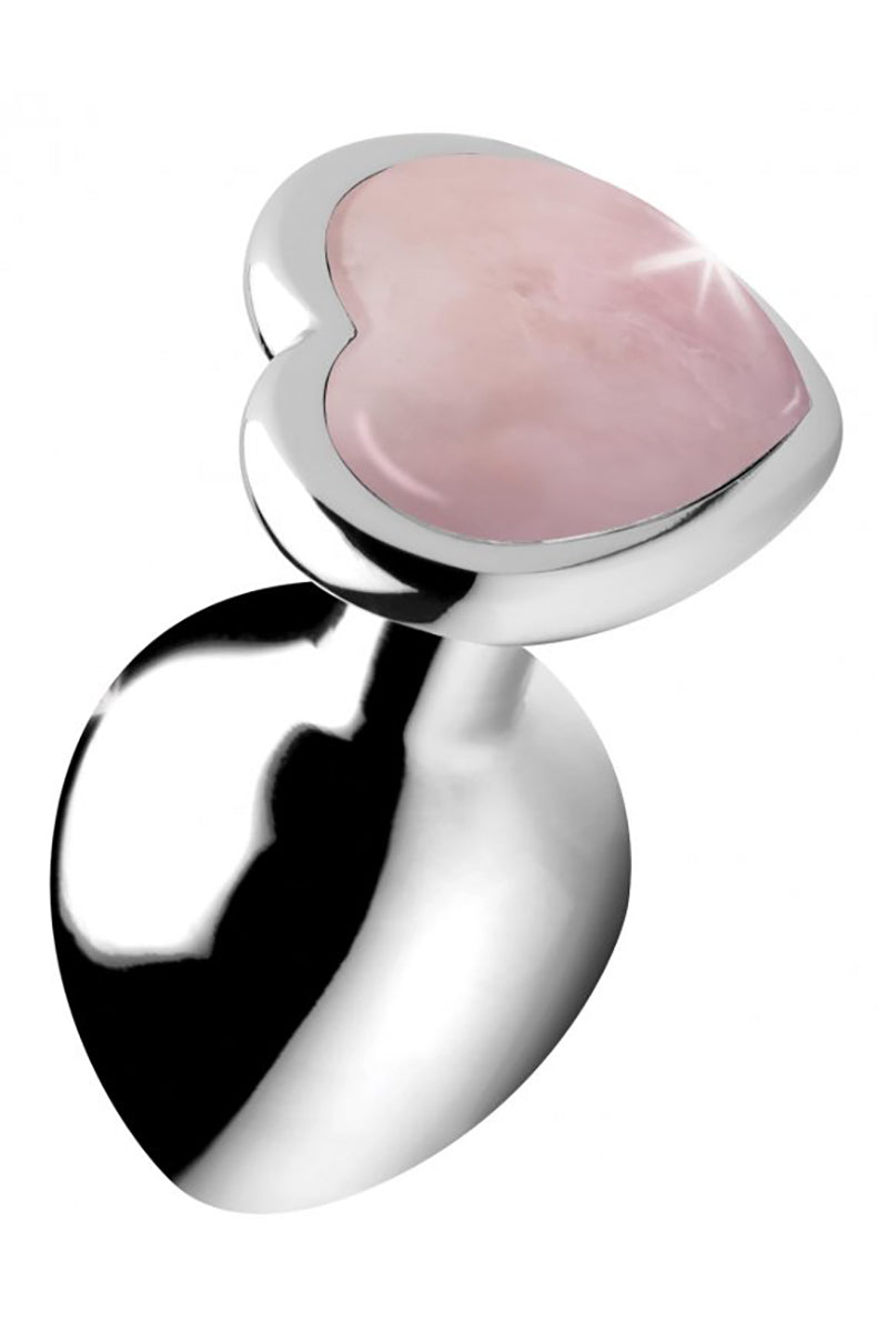 Silver metal anal plug with rose quartz heart shaped gemstone base, tilted view