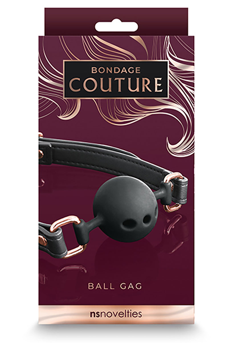 Close-up of black silicone ball showing three breathing holes and rose-gold rivets on the black PU strap.