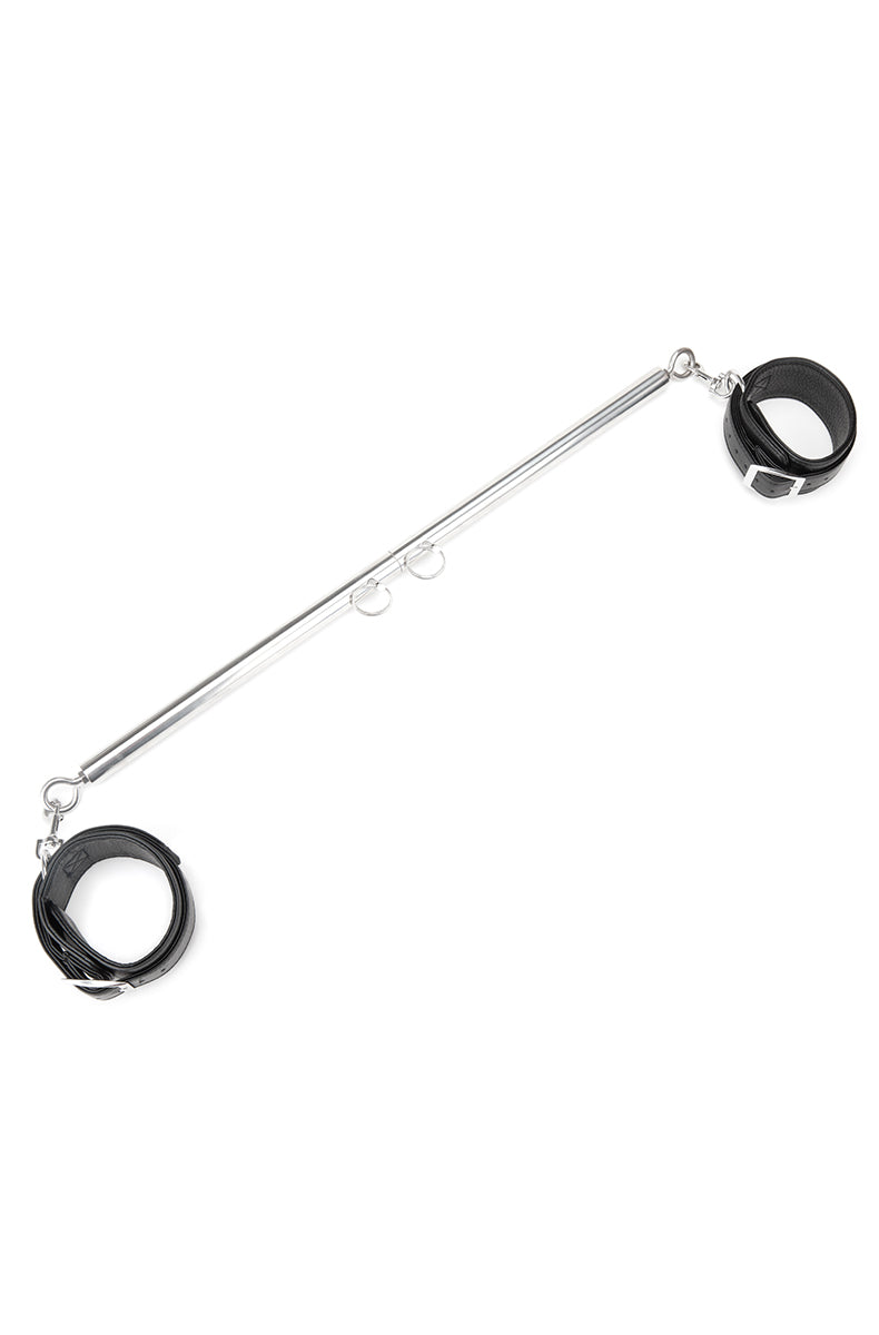 Silver chrome telescoping spreader bar with adjustment pins and a pair of black leatherette buckle cuffs at the ends.