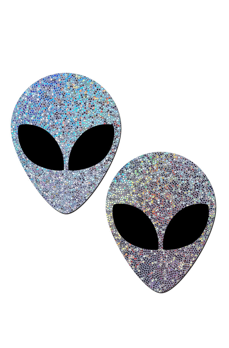 Two alien-head pasties in silver holographic glitter with solid matte-black almond-shaped eyes.