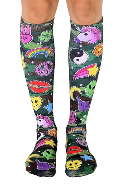Knee-high socks with green camo background covered in pop-art patches: unicorns, rainbows, peace signs, smiley faces, lips, aliens, and four-leaf clovers.