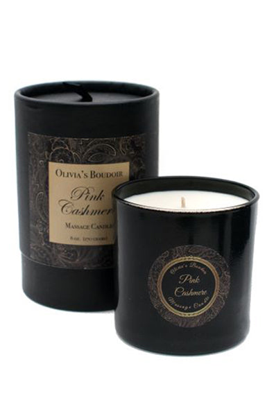 Olivia's Boudoir Pink Cashmere massage candle in a glass jar with pink label, on a white background.