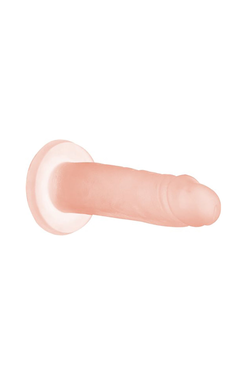 Peach Bellini Cocktails 5.5 in silicone dildo stuck to a wall by its suction cup base.