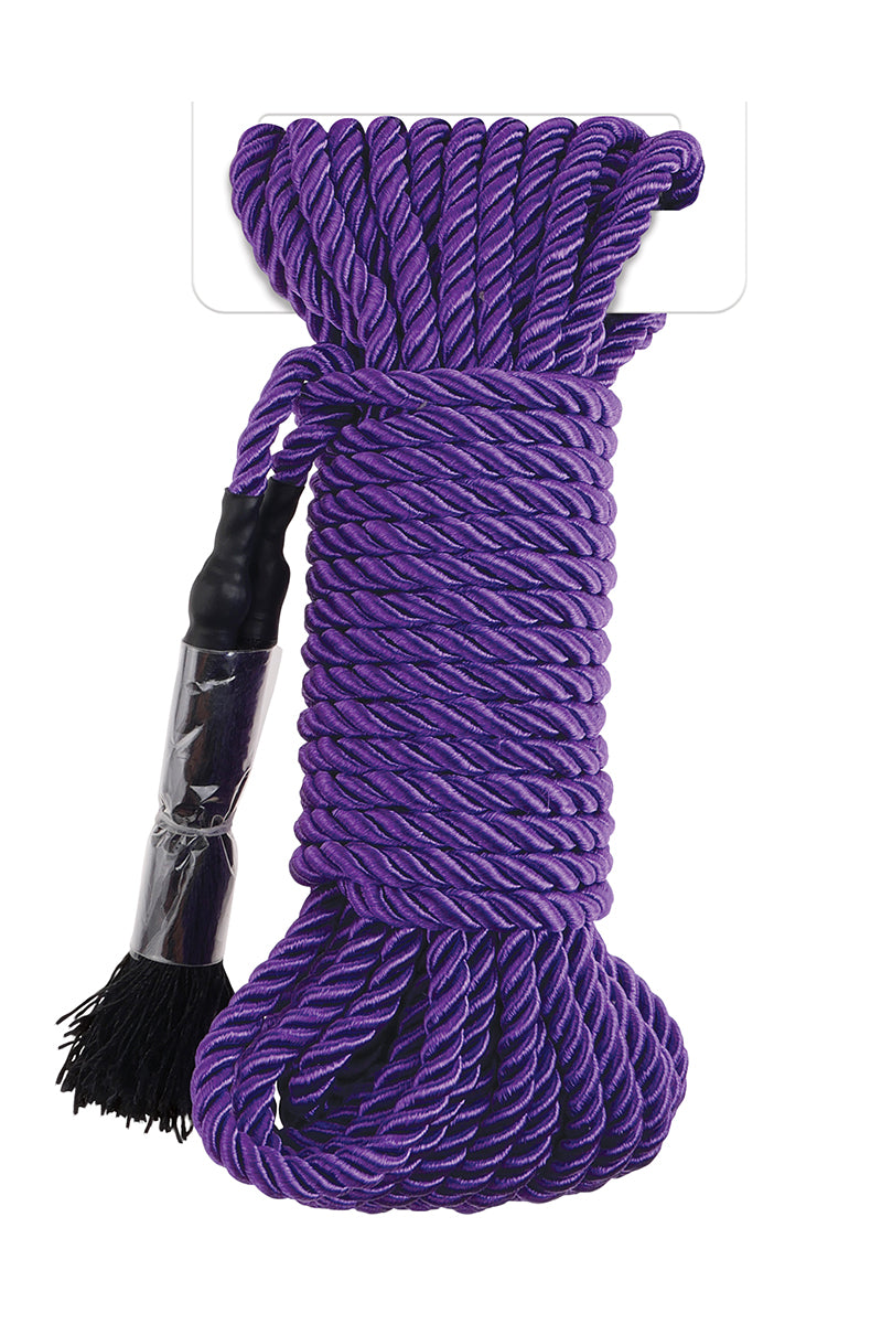 Coiled bundle of glossy purple braided silky bondage rope with sealed end caps and small fringe tassels.