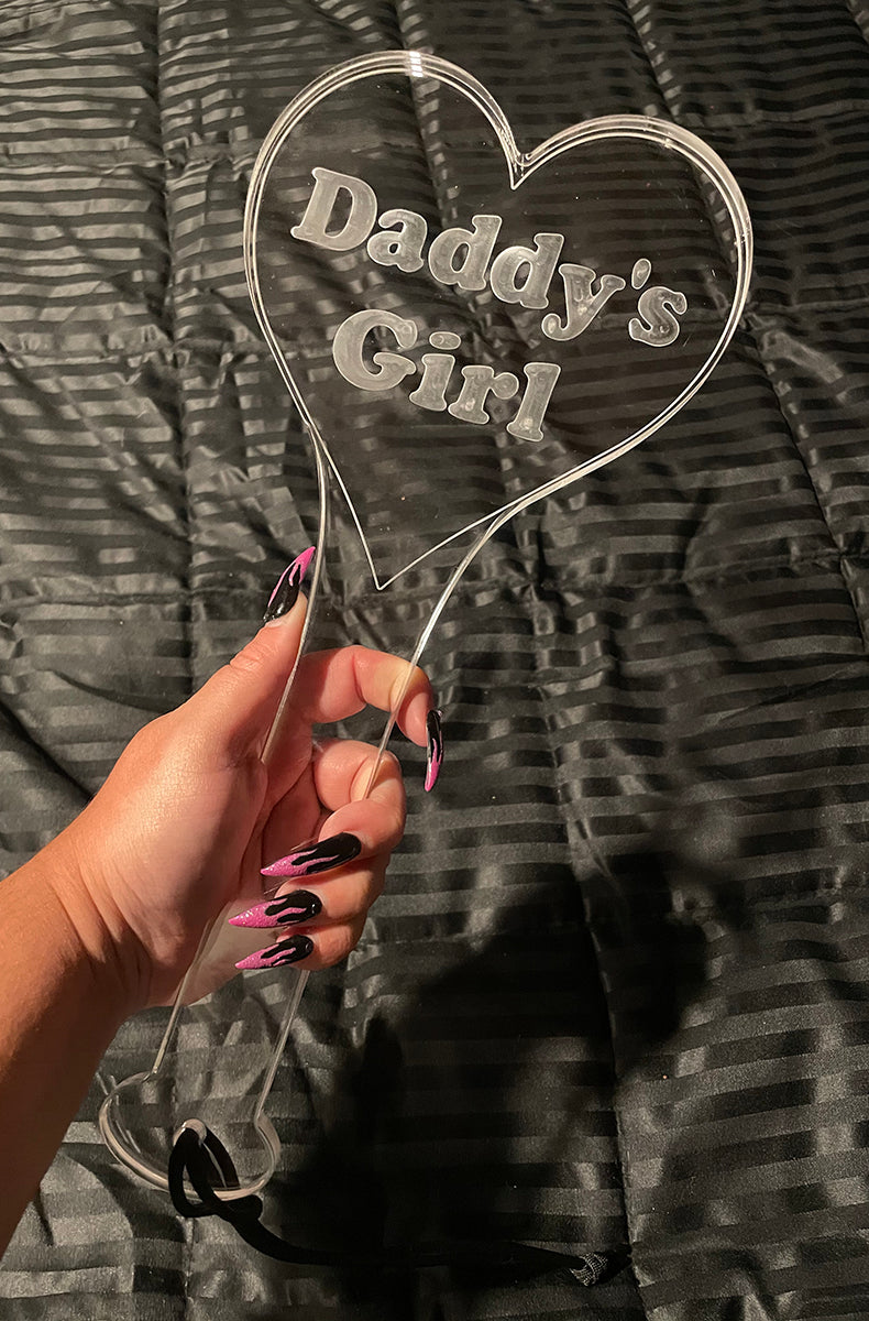 Clear cast acrylic heart-shaped paddle with Daddy's Girl engraved in soft cursive lettering inside the heart.