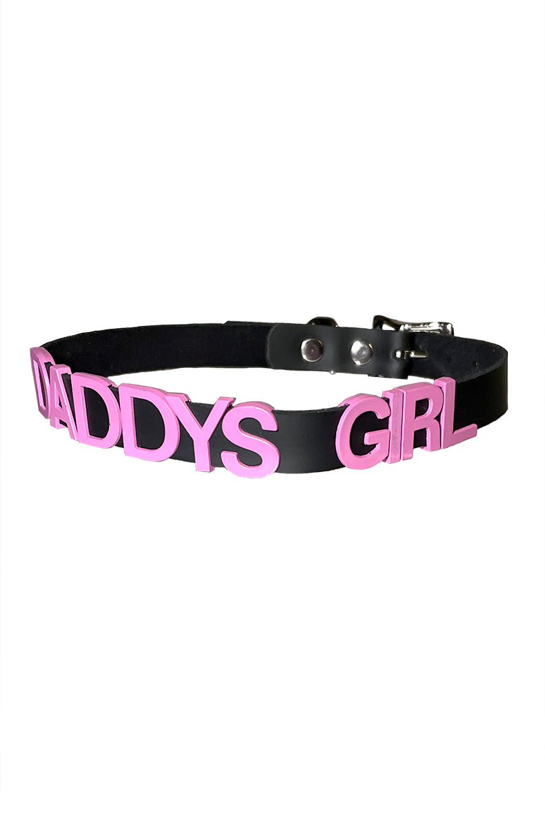 Black vegan-leather collar with "DADDYS GIRL" in bold pink raised block lettering.