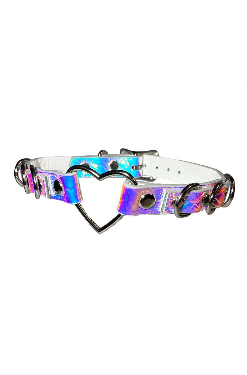 Holographic purple-pink-blue vegan leather collar with a silver heart-shaped opening ring at the front and multiple silver D-rings along the strap.