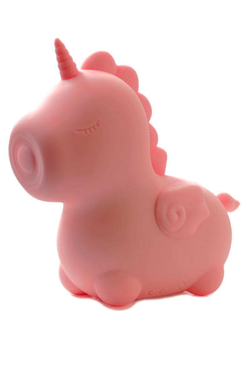 Pink silicone Unihorn Heart Throb unicorn vibrator standing in front of its packaging insert.