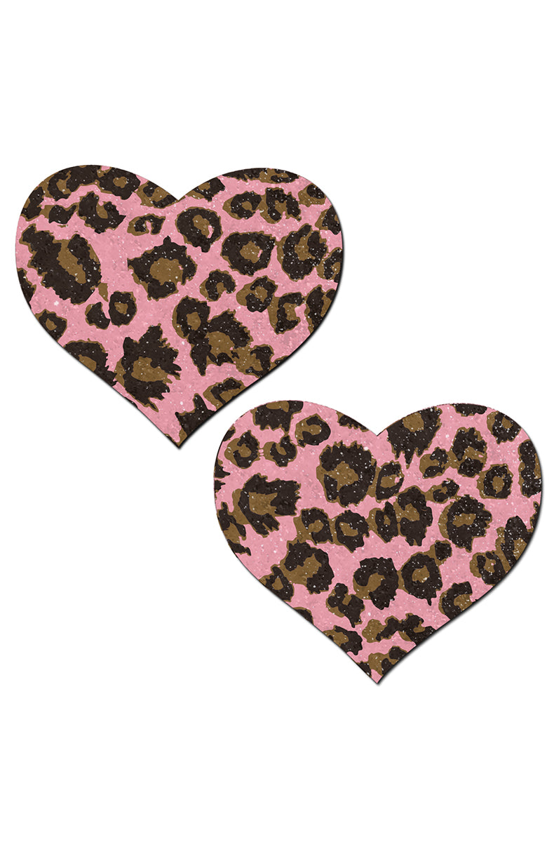 Two heart-shaped pasties on a pink-glitter base printed with classic cheetah leopard spots in tan and dark brown.