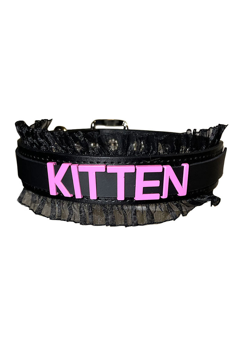 Black vegan-leather collar with "KITTEN" in bold pink raised lettering and a black sheer organza ruffle along both edges.