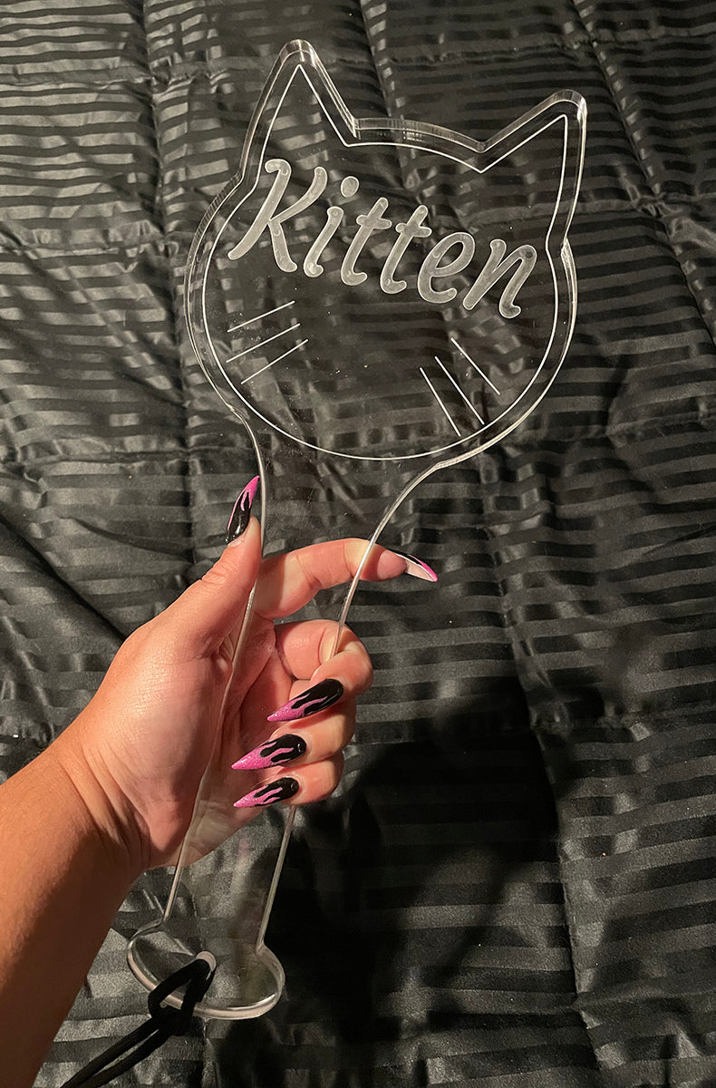 Clear cast acrylic paddle in a cat-head silhouette with Kitten engraved in the center and etched whisker lines.