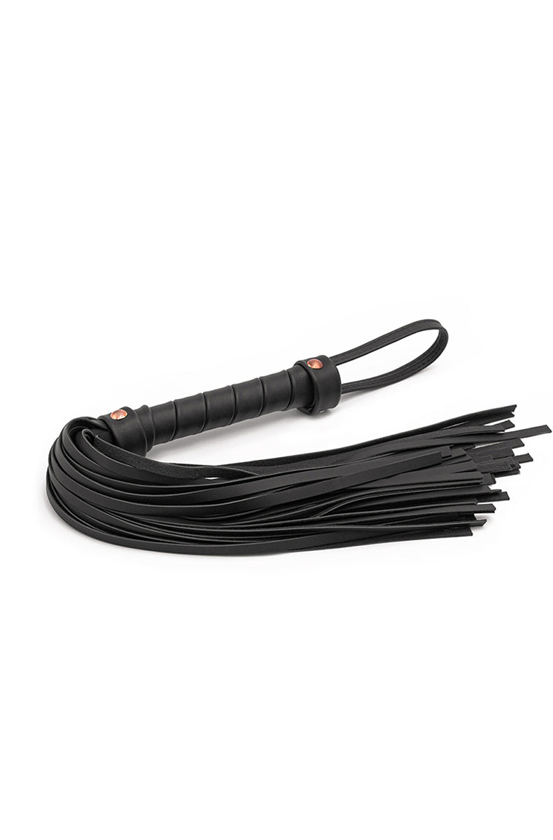 Black synthetic-leather flogger with thin falls on a rose-gold wrapped handle with a rose-gold strap loop at the top.