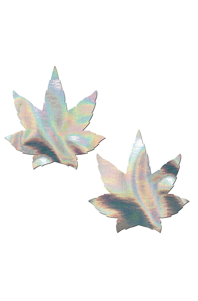 Two cannabis-leaf-shaped pasties in iridescent silver holographic film with an oil-slick rainbow shift through pink, blue, peach, mint, and lavender.