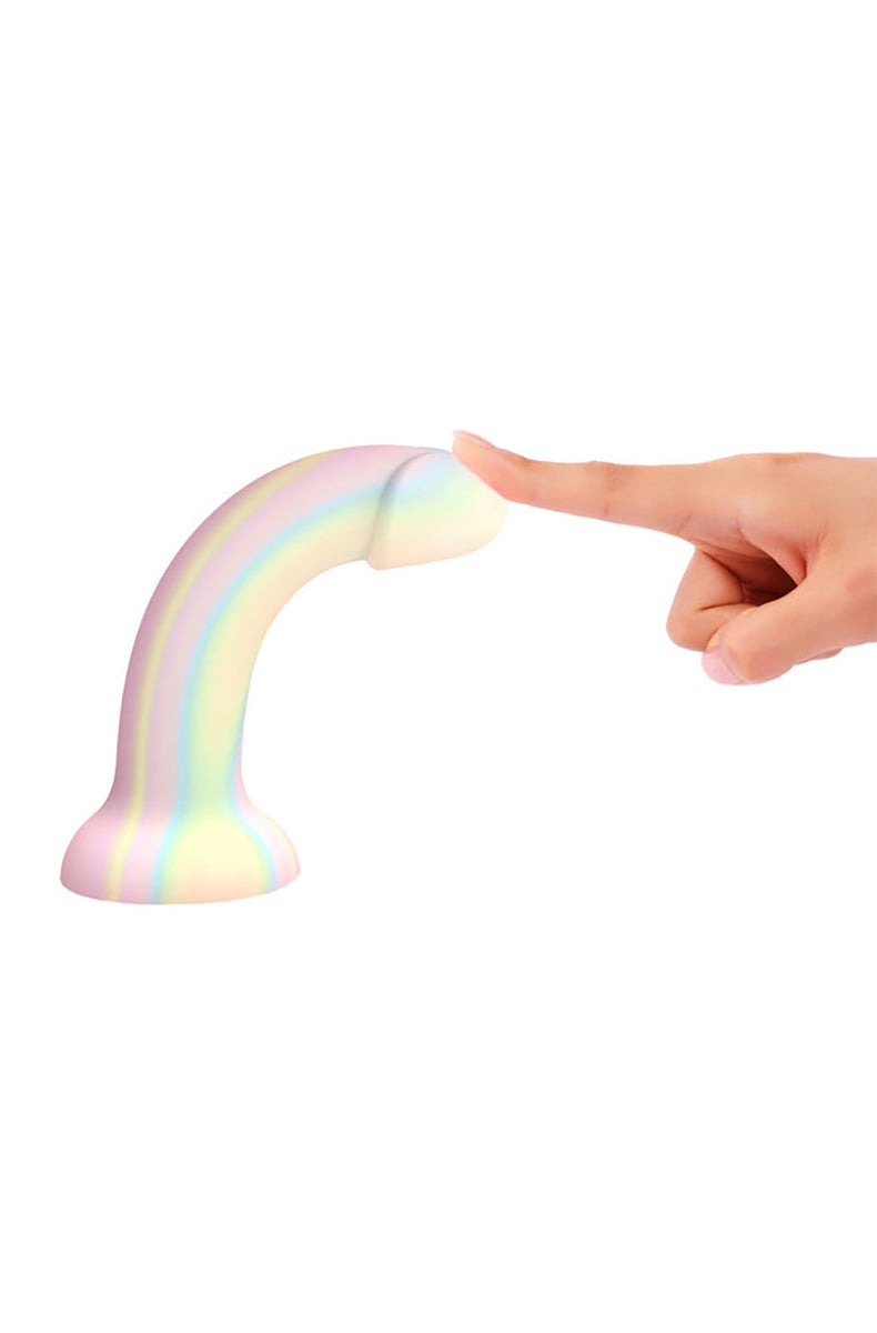 Side angle of Dildoll Fantasia pastel rainbow glow silicone dildo on flared suction base.