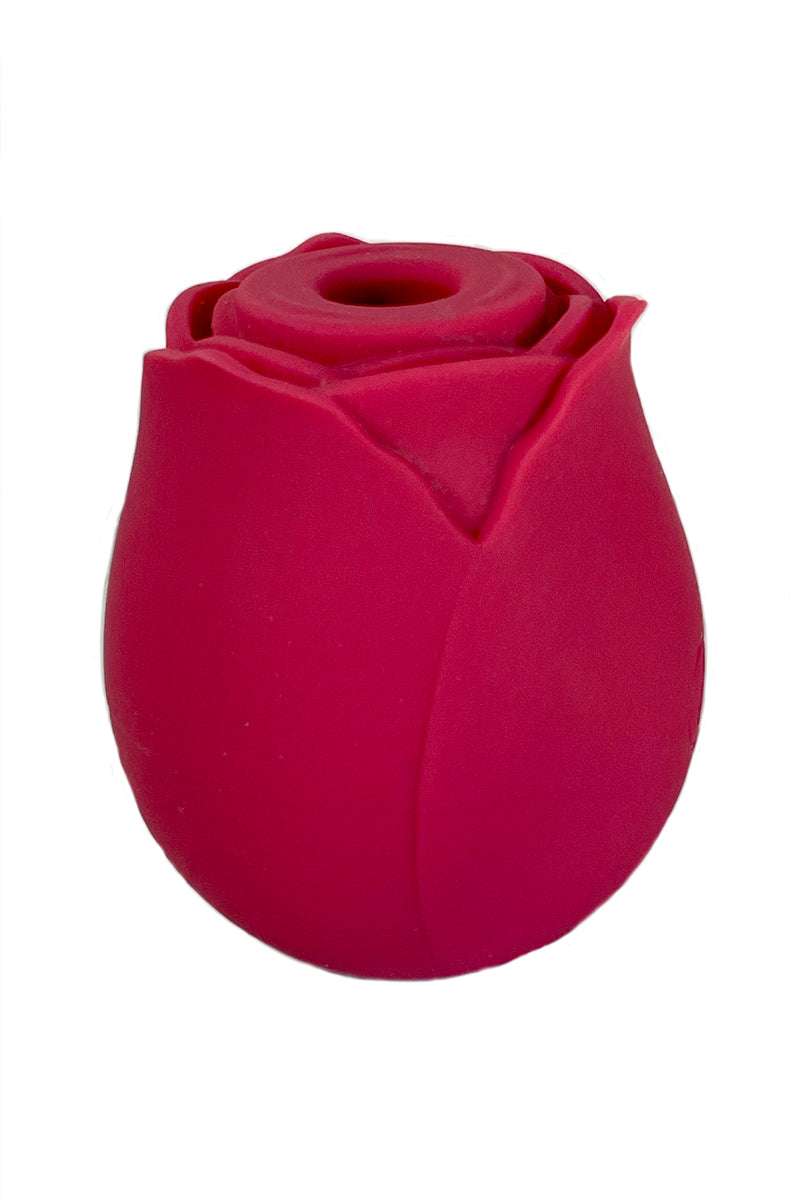 Red silicone rose-shape clitoral suction vibrator, palm-sized, with central nozzle in the middle of sculpted petals.
