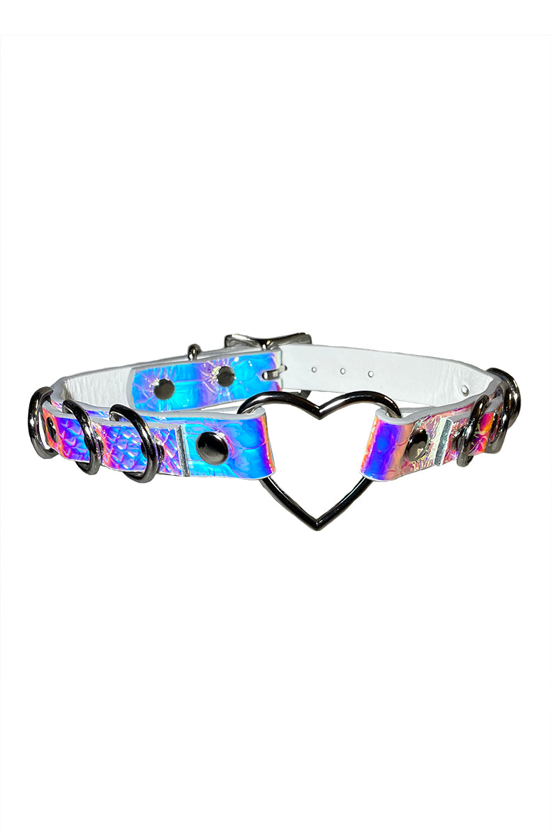 Holographic purple-pink-blue vegan leather collar with a silver heart-shaped opening ring at the front and multiple silver D-rings along the strap.
