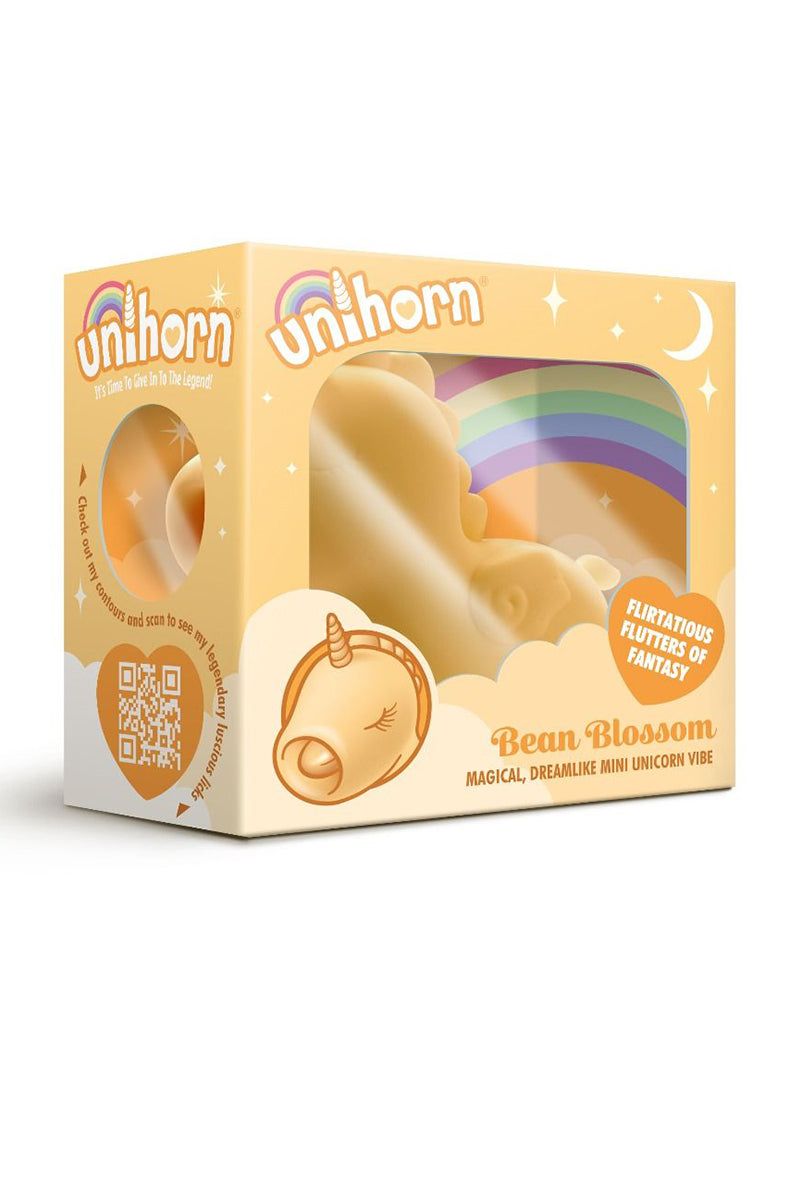 Open packaging of the Unihorn Bean Blossom showing the yellow silicone unicorn vibrator inside the rainbow box.